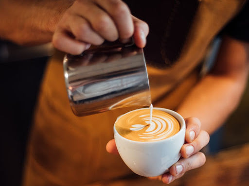 Barista pouring Flat White coffee