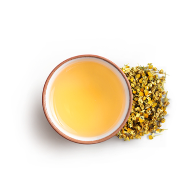 Cup of herbal chamomile tea with tea flowers on side 