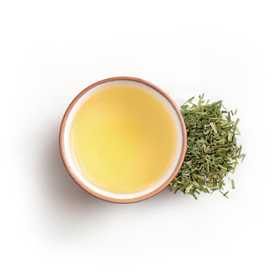 Cup of lemongrass and ginger tea with leaves on side 